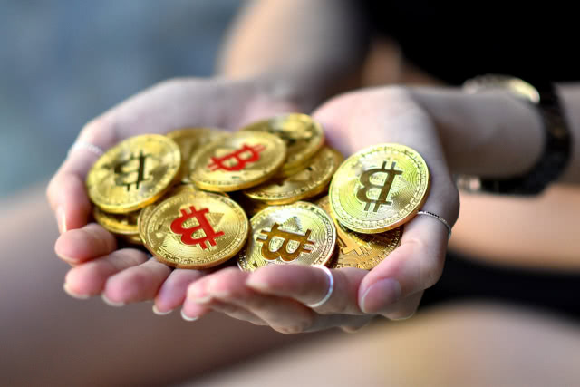 Bitcoins in hands