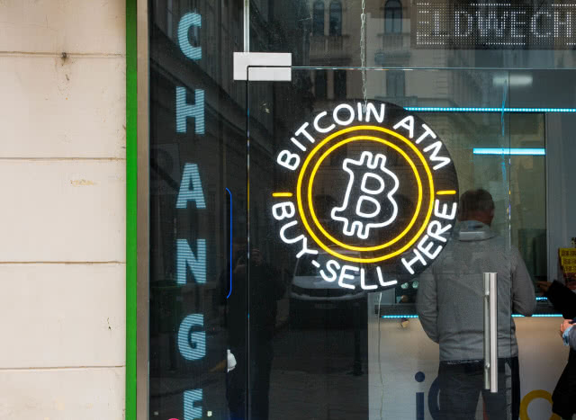 'Bitcoin ATM / Buy-sell here' sign on a store window
